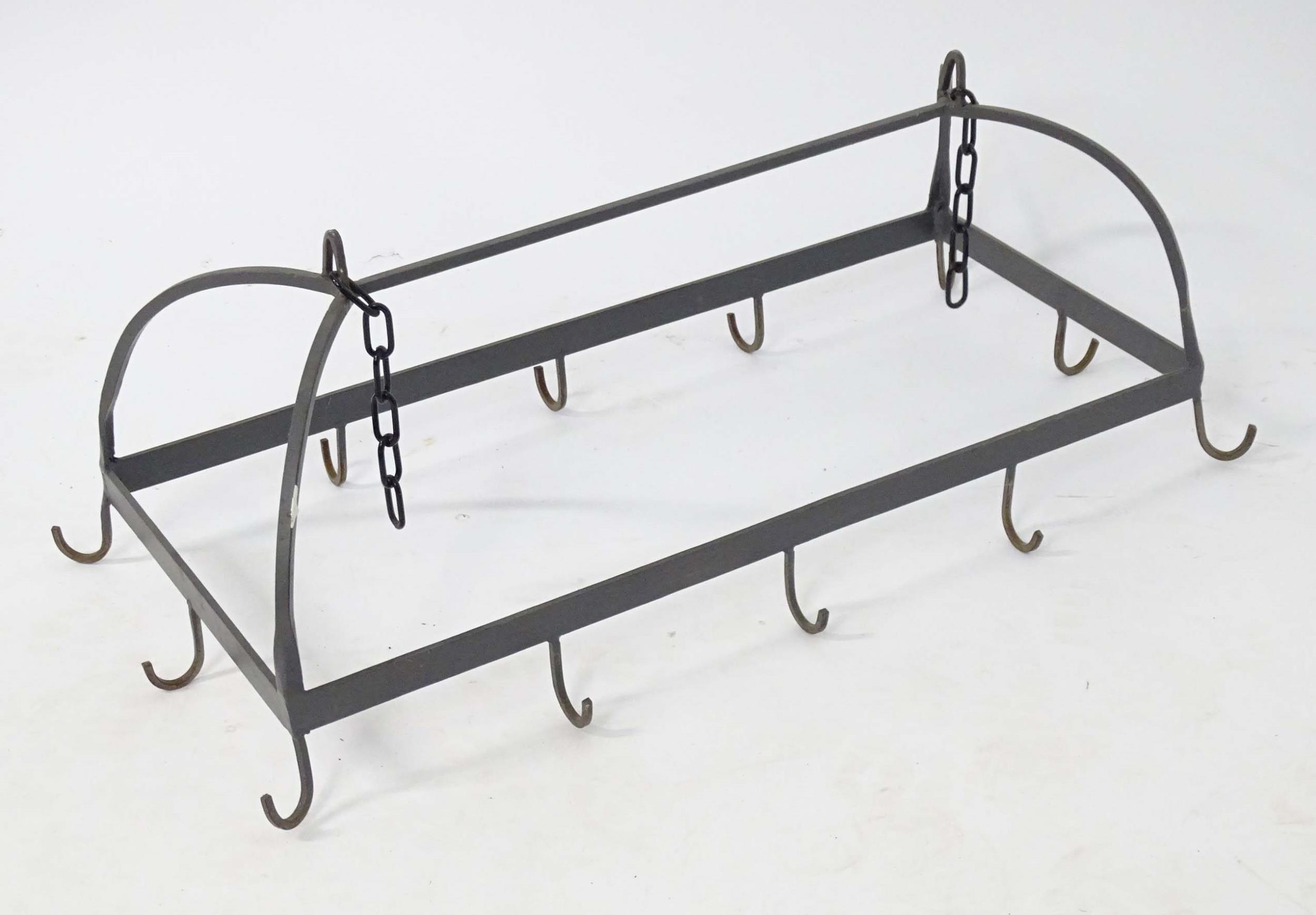 A cast kitchen pot and pan hanger with twelve hooks. Approx. 52" long Please Note - we do not make