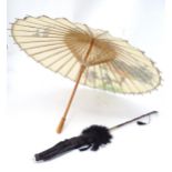 An Oriental parasol, together with another. Largest 28 1/2" long (2) Please Note - we do not make