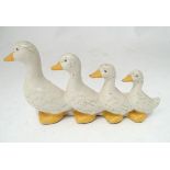 A cast iron door stop / door porter modelled as graduated ducks. Approx. 6" high x 11" wide x 4"