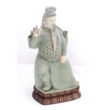 An Oriental figure on a base. Approx. 17 1/2" high Please Note - we do not make reference to the