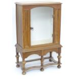 A William and Mary style pier cabinet with glazed door. Approx 40" high x 24 1/2" wide x 13 1/4"