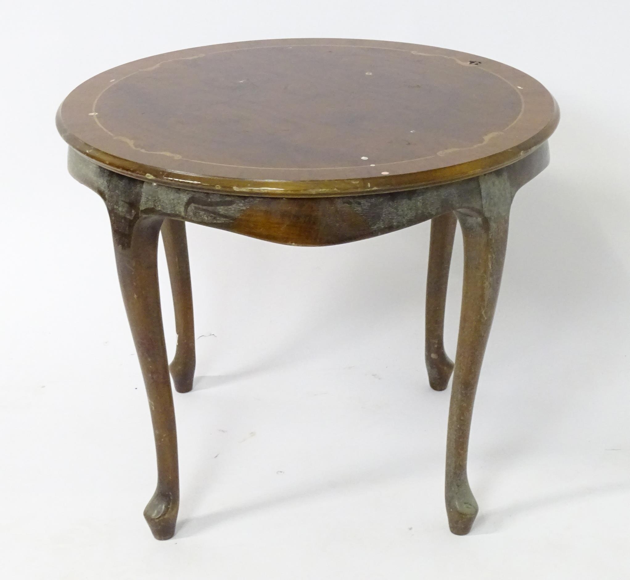 A late 20thC inlaid occasional table. Approx. 21 1/2" high Please Note - we do not make reference to