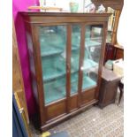 A 20thC glazed oak display cabinet with four shelves. Approx. 64 1/2" high x 45" wide x 15 1/2" deep