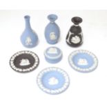 Seven Wedgwood Jasperware items to include small vases with flared rims, a bottle vase, pot and