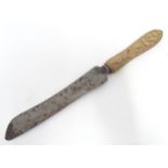 A Victorian bread knife by Harrison & Co. of Sheffield with a wooden handle. Approx. 12 1/2" overall