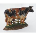 A painted door stop / door porter modelled as a cow Please Note - we do not make reference to the