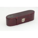 A 20thC red leather baby's christening display box, with white metal mount. Approx. 8 1/4" long