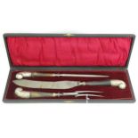 An early 20thC cased carving set comprising fork, knife and sharpener, each with silver plate