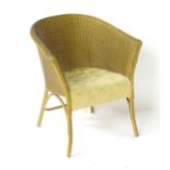 A Lusty Lloyd Loom armchair Please Note - we do not make reference to the condition of lots within