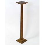 An oak jardiniere stand with squared top and fluted column. Approx. 36" high Please Note - we do not