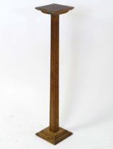 An oak jardiniere stand with squared top and fluted column. Approx. 36" high Please Note - we do not