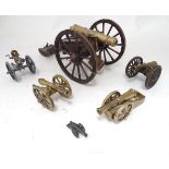 A quantity of brass desk cannons and a gatling gun. Largest approx. 16" long x 8" wide x 7 1/4" high