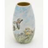A Branksome vase of ovoid form with hand painted decoration depicting a landscape scene with a