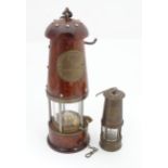 A reproduction Davy lamp. Together with a smaller example. Largest approx. 10 1/2" high (2) Please