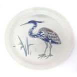A studio pottery plate with stylised heron / bird decoration. Approx. 8 1/2" diameter Please