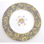 A Minton cabinet plate in the pattern Brocade with central floral motif. The blue border with gilt