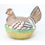 A 20thC ceramic egg basket formed as a hen on nest. Approx. 10" wide Please Note - we do not make