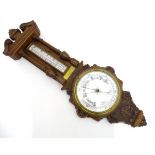 An aneroid barometer with inset brass plaque dated 1915. Approx. 34" high x 12" wide Please Note -