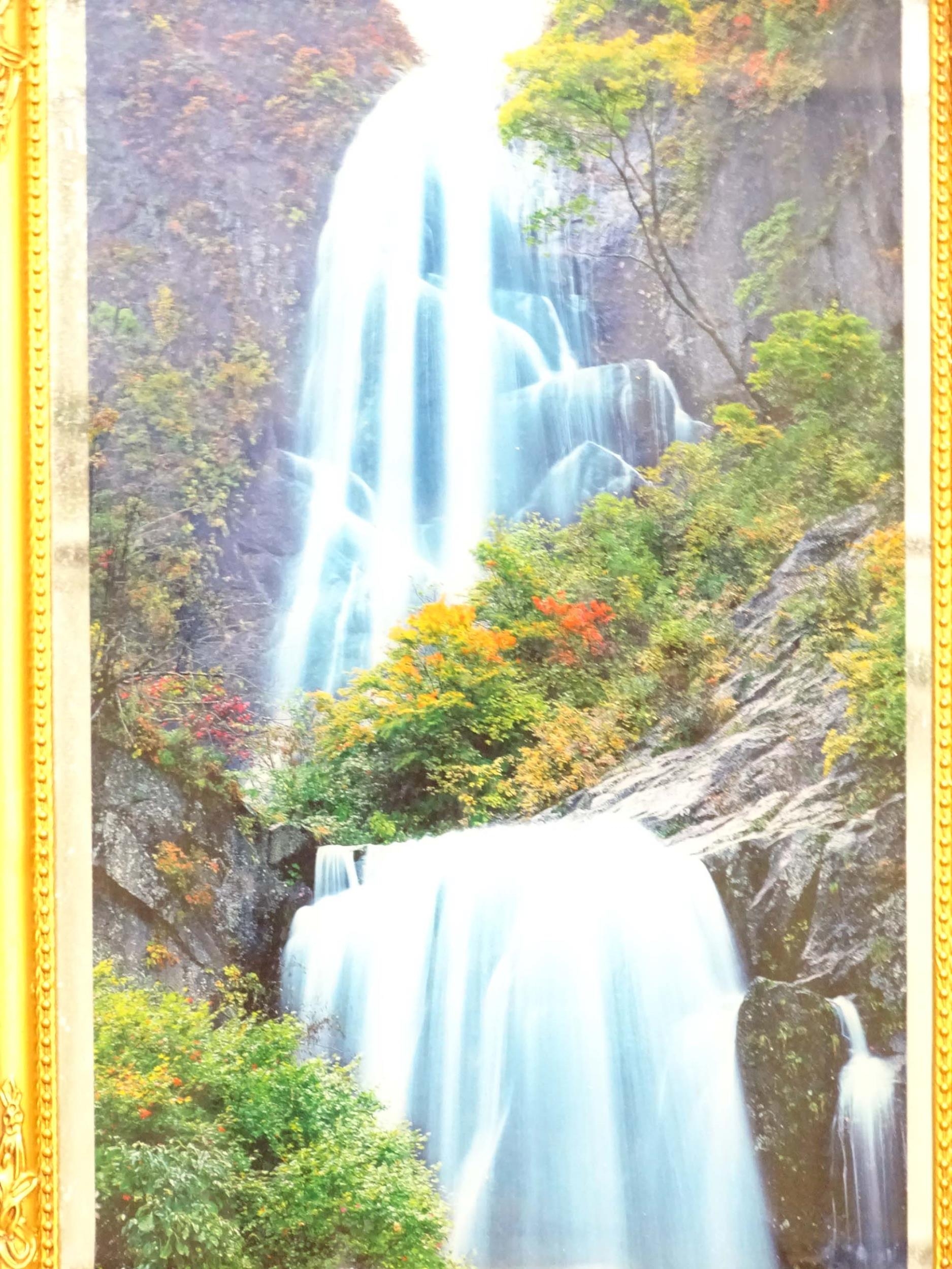 A backlit photograph of a waterfall with a mirrored background and a gilt frame. Approx. 26" x 18" - Image 3 of 4