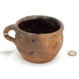 A 19thC large terracotta mug with traces of treacle glaze. Approx. 3 1/2" high x 4 3/4" diameter