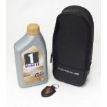 A Porsche Mobil 1 promotional bottle of oil and case. Together with a Porsche keyring (2) Please