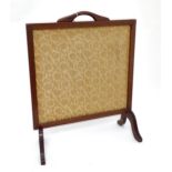 A mahogany firescreen with inset upholstered panel. Approx. 26" high x 21" wide Please Note - we