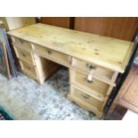 A pine pedestal desk, the top with three drawers. Approx. 28 1/2" high x 34 1/4" wide x 22 1/2" deep