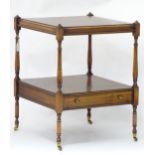 A 20thC mahogany two tier occasional table with single drawer on four turned legs. Approx. 23"