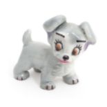 A small ceramic model of a cartoon dog, Approx. 1 1/2" high Please Note - we do not make reference