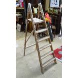 A 20thC step ladder. Approx. 63" high Please Note - we do not make reference to the condition of