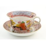 An oversized Burslem cup and saucer decorated with a bridge and tower in a landscape with the