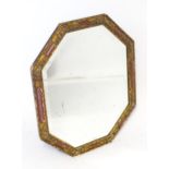 A mirror with a red and gilt frame Please Note - we do not make reference to the condition of lots