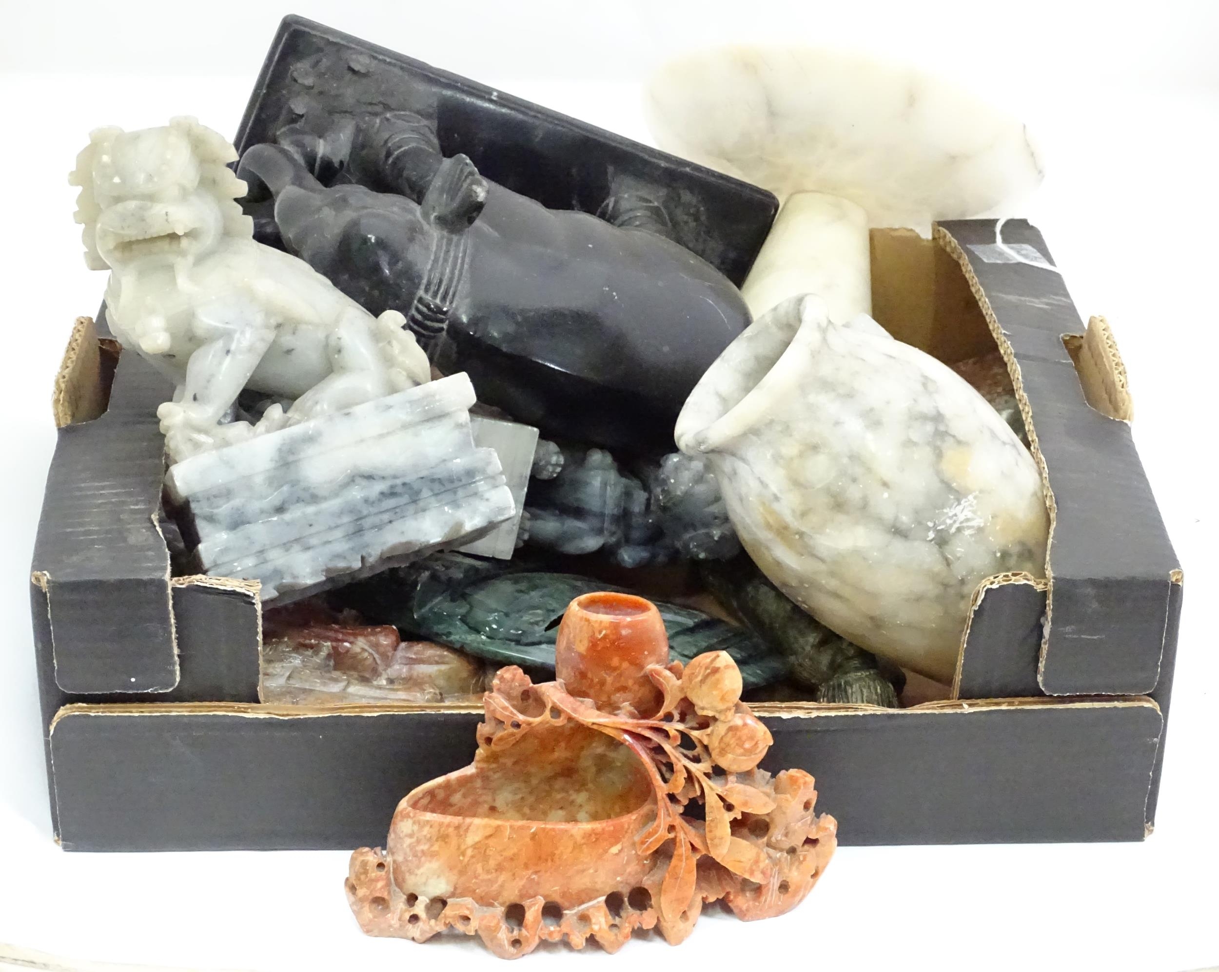 A quantity of Oriental carved soapstone items to include foo dogs, elephant, vase, tazza, etc.