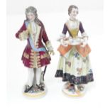 Two Continental figures, one modelled as a lady with a tea tray, the other modelled as a
