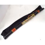 A Didgeridoo in cloth bag . Approx. 56" long Please Note - we do not make reference to the condition