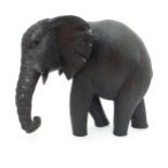 A carved model of an elephant. approx 12" long Please Note - we do not make reference to the
