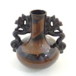 A Oriental twin handled bottle vase with stylised dragon detail to handles. Approx. 10 1/4" high