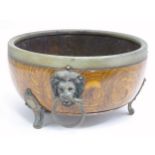 A wooden bowl with brass mounts and lion mask handles. Approx. 10" diameter Please Note - we do