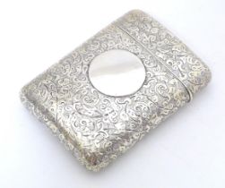 A Victorian silver cigarette case of shaped form with engraved acanthus scroll decoration hallmarked