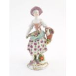 A Derby style figure modelled as a fruit seller with a fruit in her apron and a basket of flowers.