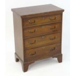 A Georgian style mahogany chest of drawers with a rectangular top above four graduated drawers