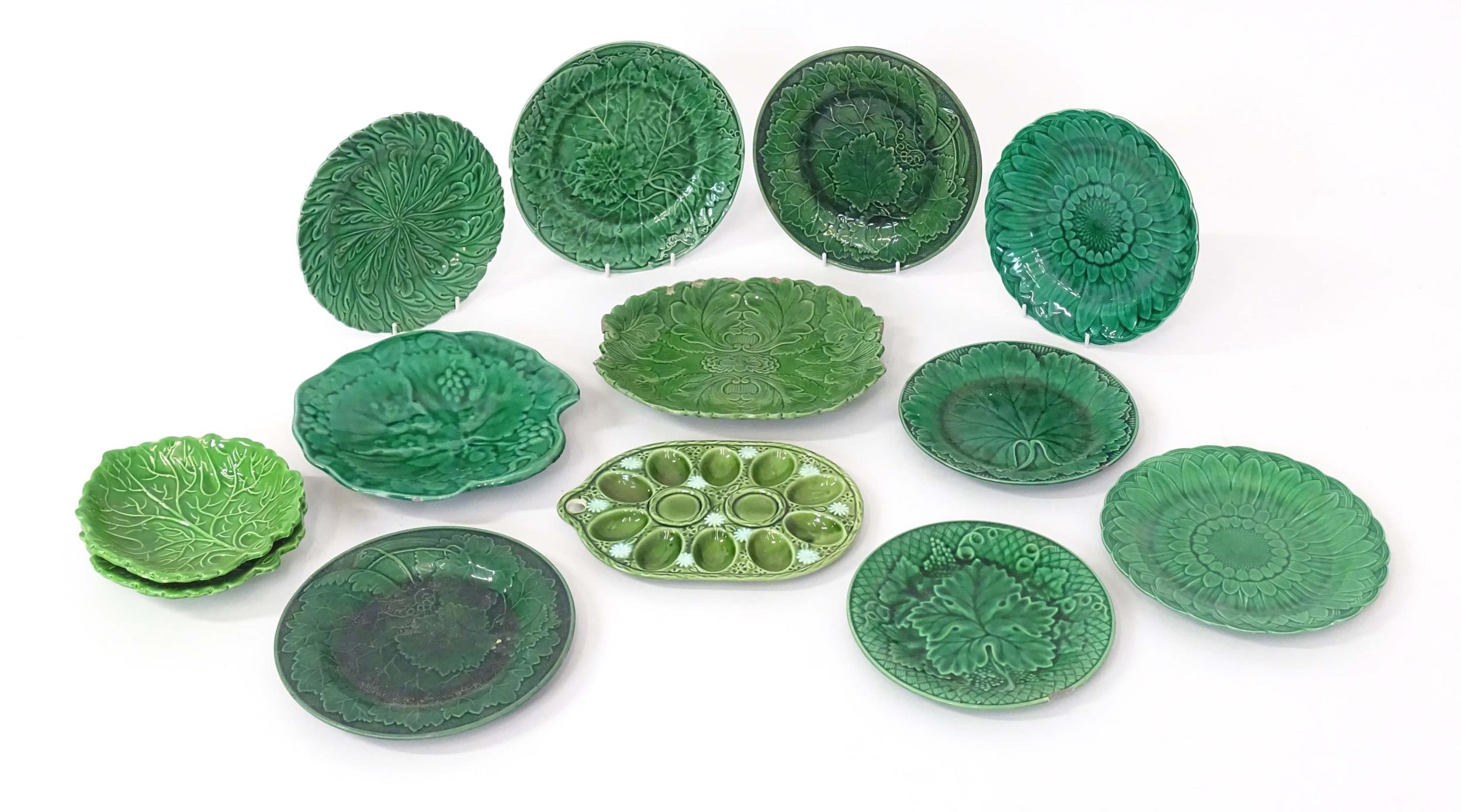 A quantity of assorted majolica leaf plates to include examples by Wedgwood, Davenport, etc. Some