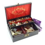 A jewellery box containing assorted costume jewellery together with some silver jewellery, a shell