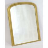 A gilt painted Victorian mirror of ached form. 32" wide x 41" high. Please Note - we do not make