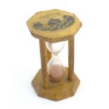 A 19thC Mauchline ware sand timer / hourglass, the octagonal top decorated with a vignette depicting