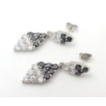 A pair of silver drop earrings set with cubic Zirconia and black stones 1 1/2" long Please Note - we