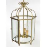 A 20thC pendant lantern ceiling light, the brass octagonal frame with bevelled glass panes, the