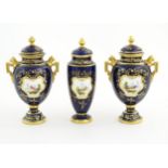 Two Coalport vase and covers with twin handles decorated with hand painted exotic bird vignettes and