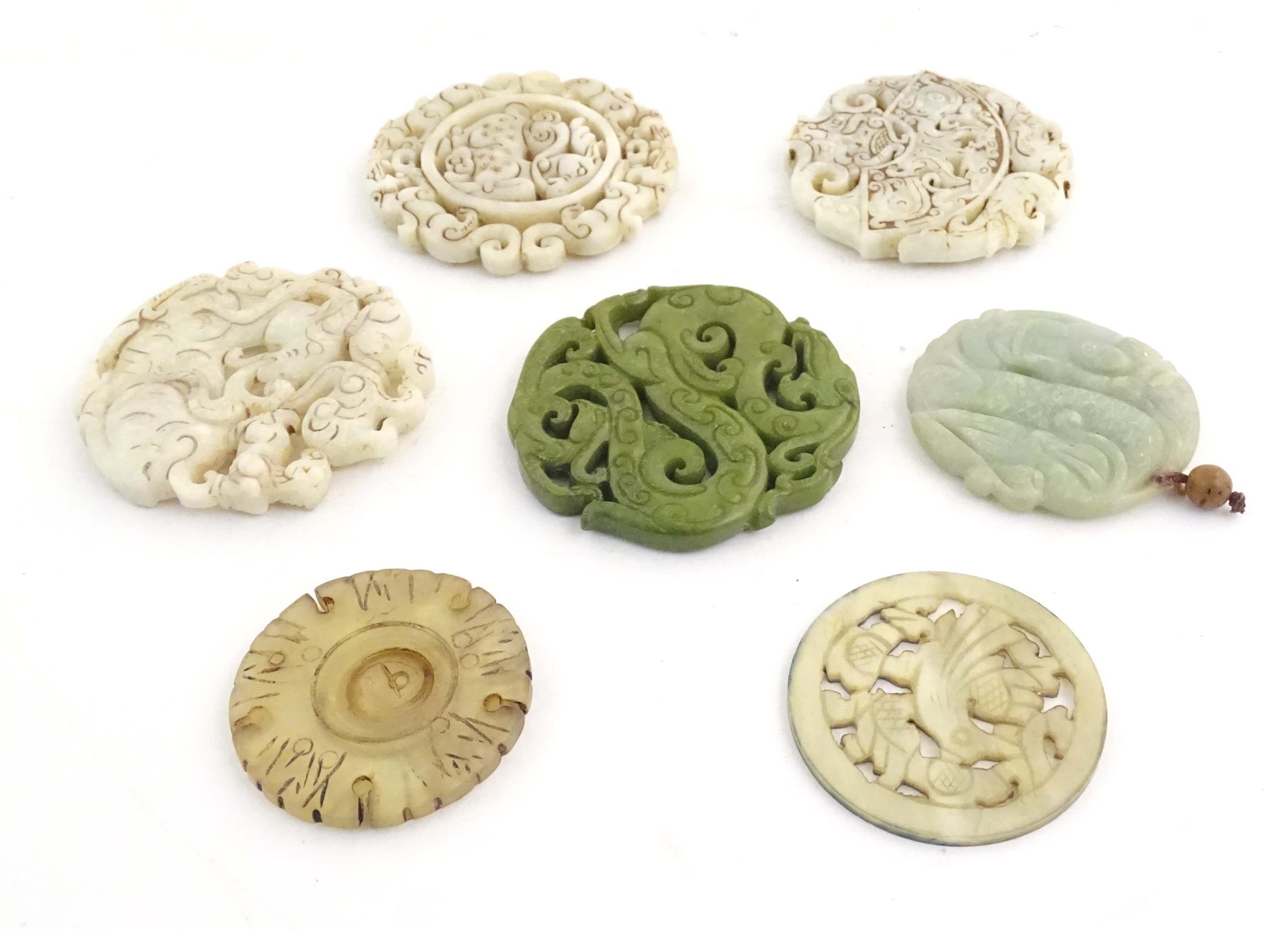 Seven assorted carved Oriental roundels / pendants, detail to include dragons, birds, stylised rams, - Image 4 of 4