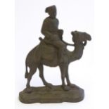 A 20thC cast door stop / door porter modelled as a man riding a camel. Approx. 11 1/4" high Please